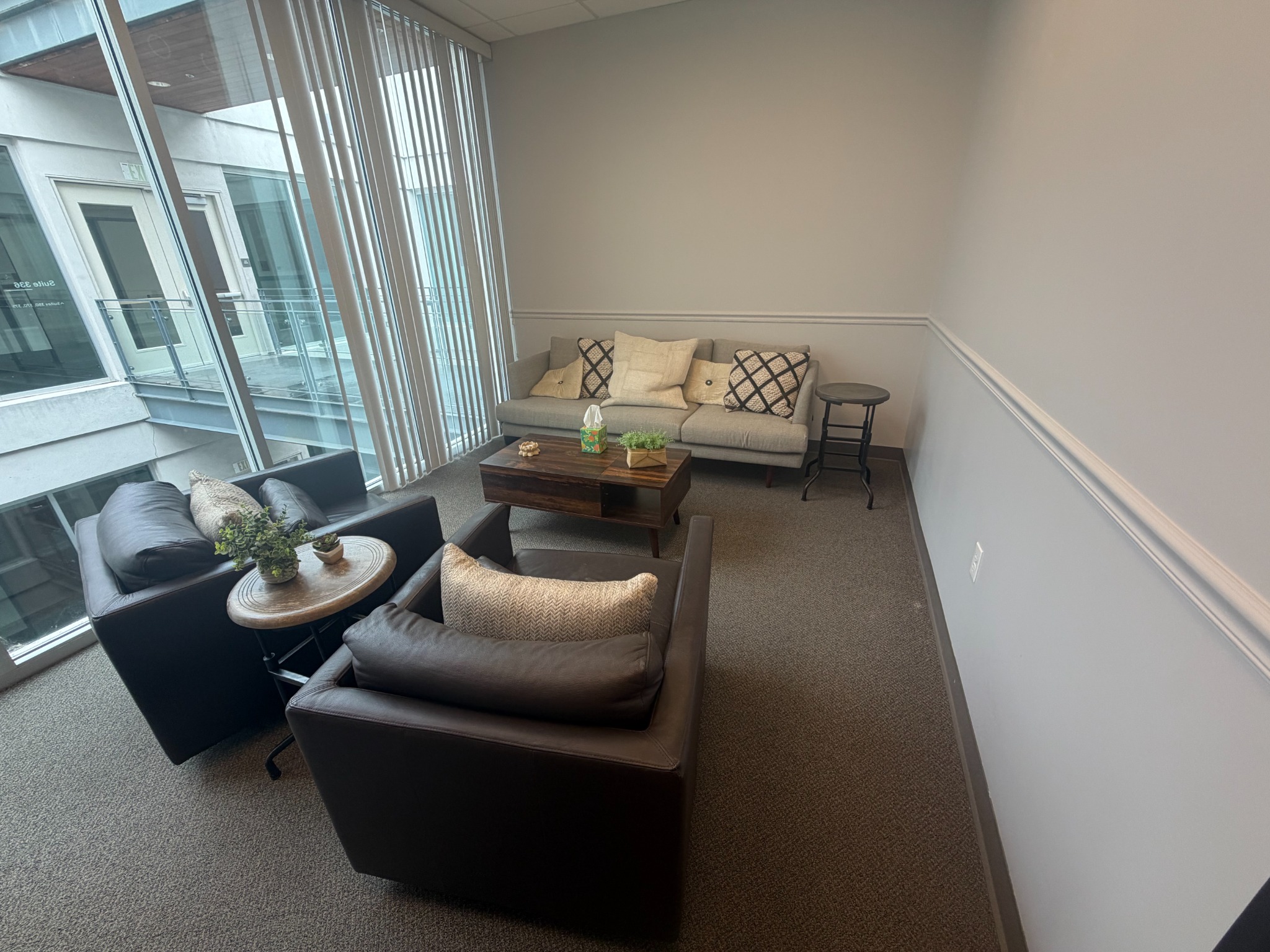 A calm, tastefully furnished therapy office seating area
